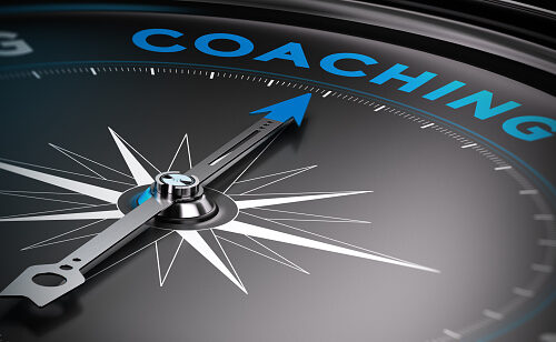 Attain personal goals, personal trainer concept. Conceptual Compass with needle pointing to the word coaching.